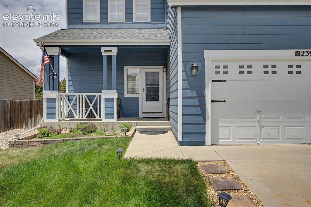 Image 1 of 28: Covered Front Entry & Attached Garage