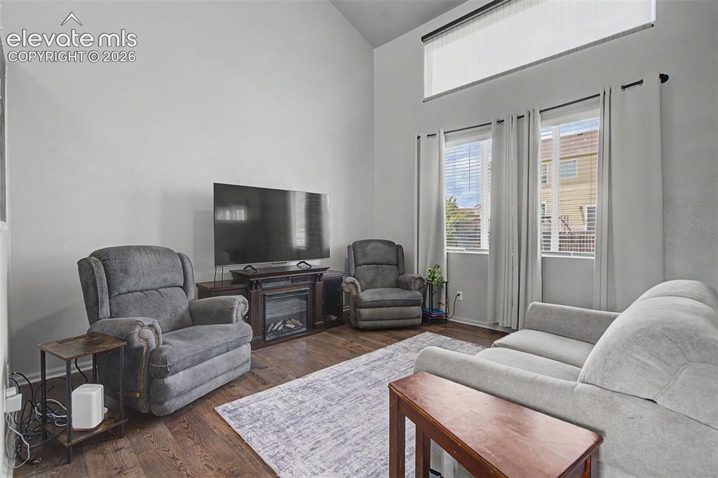 Image 4 of 28: Bright Living Room with Vaulted Ceiling and Natural Light