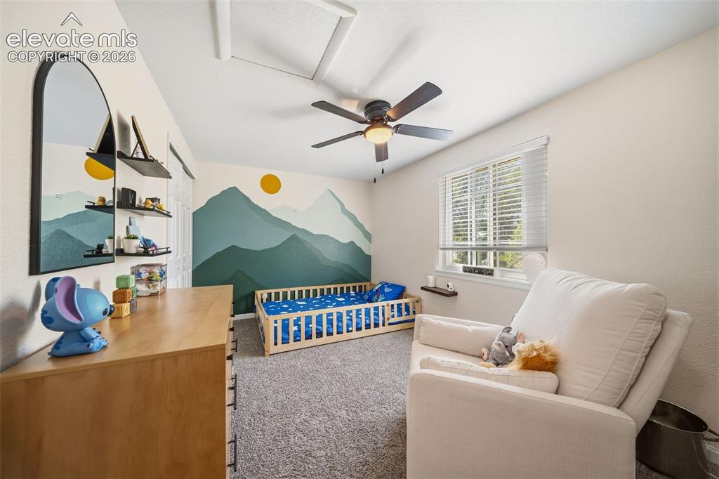 Image 25 of 39: Interior room featuring light-colored walls and grey carpet flooring