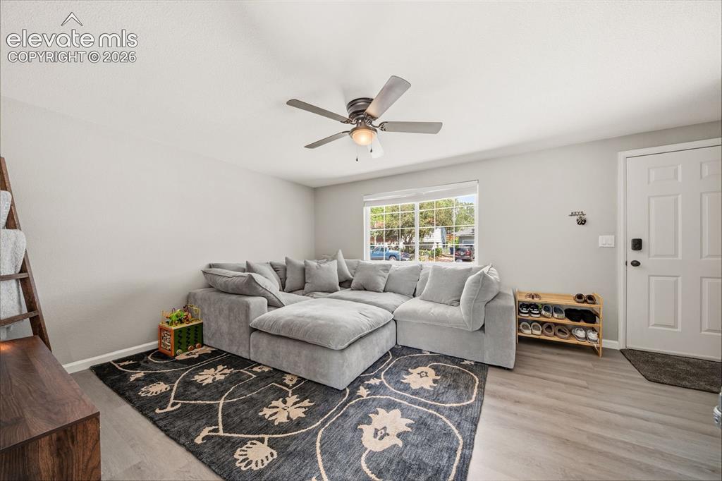 Image 7 of 39: Bedroom featuring textured walls, a ceiling fan with light fixture, and car