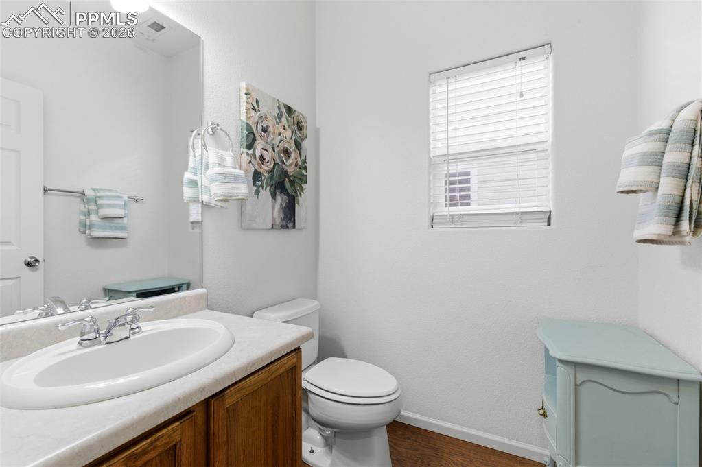 Image 20 of 44: Bathroom featuring vanity and dark wood-style floors