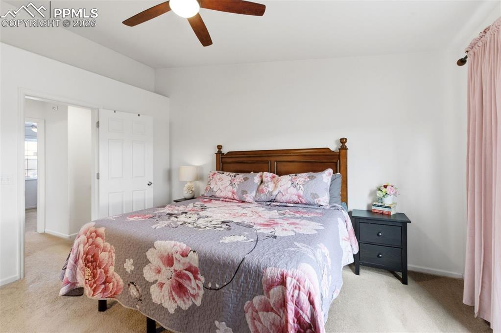 Image 22 of 44: Bedroom featuring light colored carpet and a ceiling fan