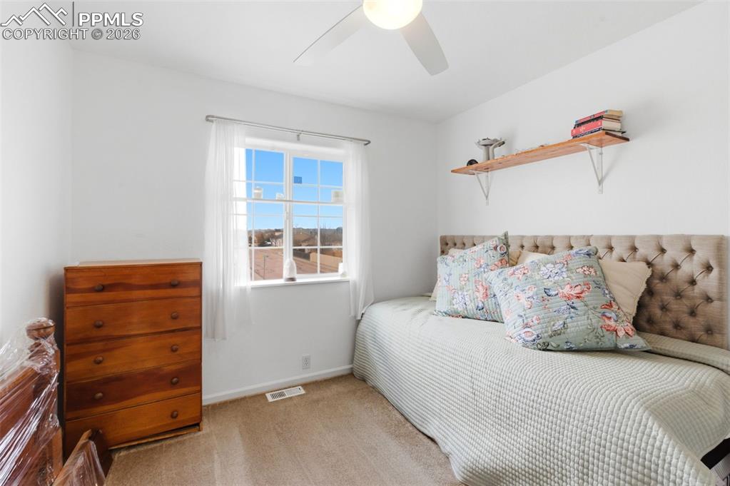 Image 27 of 44: Bedroom with light carpet and ceiling fan