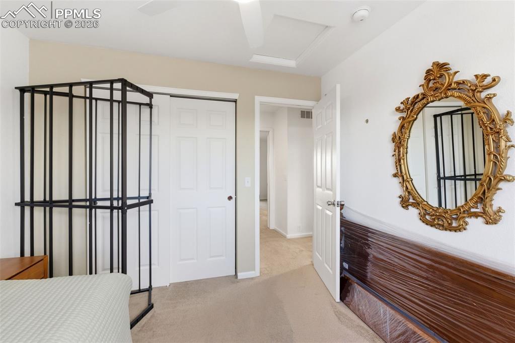 Image 28 of 44: Bedroom featuring a closet, light colored carpet, and ceiling fan