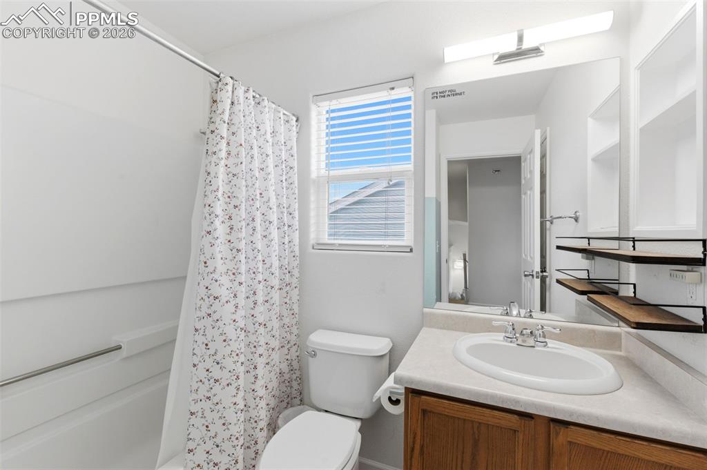Image 29 of 44: Bathroom featuring vanity and shower / bath combo with shower curtain