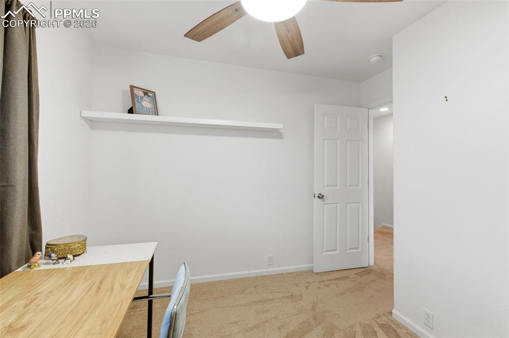 Image 31 of 44: Unfurnished office with light colored carpet and a ceiling fan