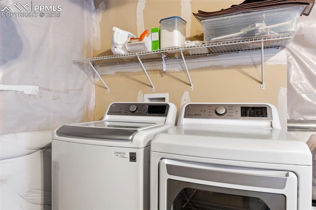 Image 32 of 44: Laundry area with washing machine and dryer