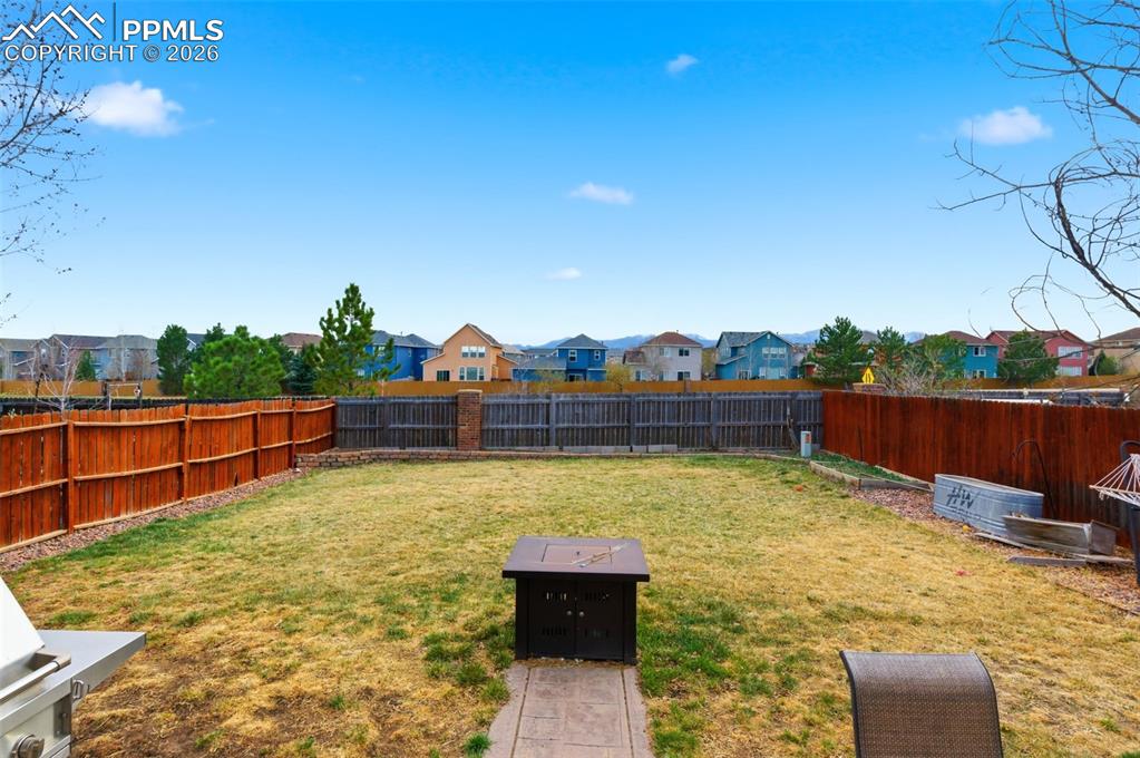Image 33 of 44: Fenced backyard with a residential view