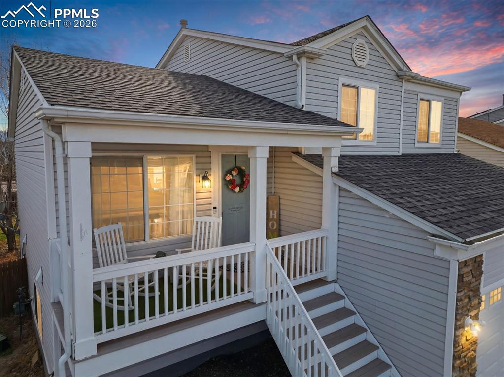 Image 5 of 44: View of front of house with roof with shingles and covered porch