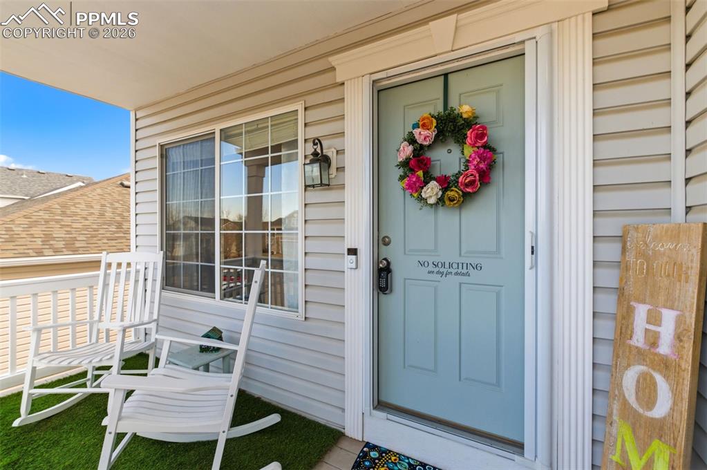Image 6 of 44: View of exterior entry with a shingled roof