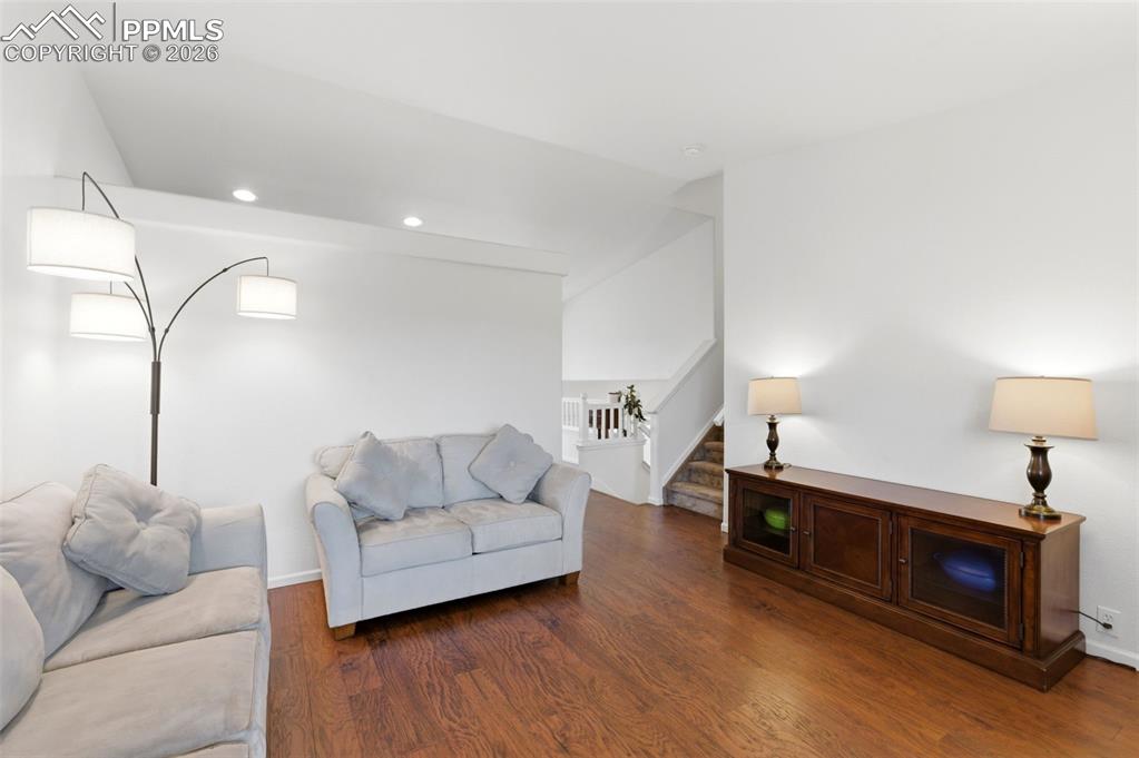 Image 9 of 44: Living area with dark wood-type flooring and recessed lighting