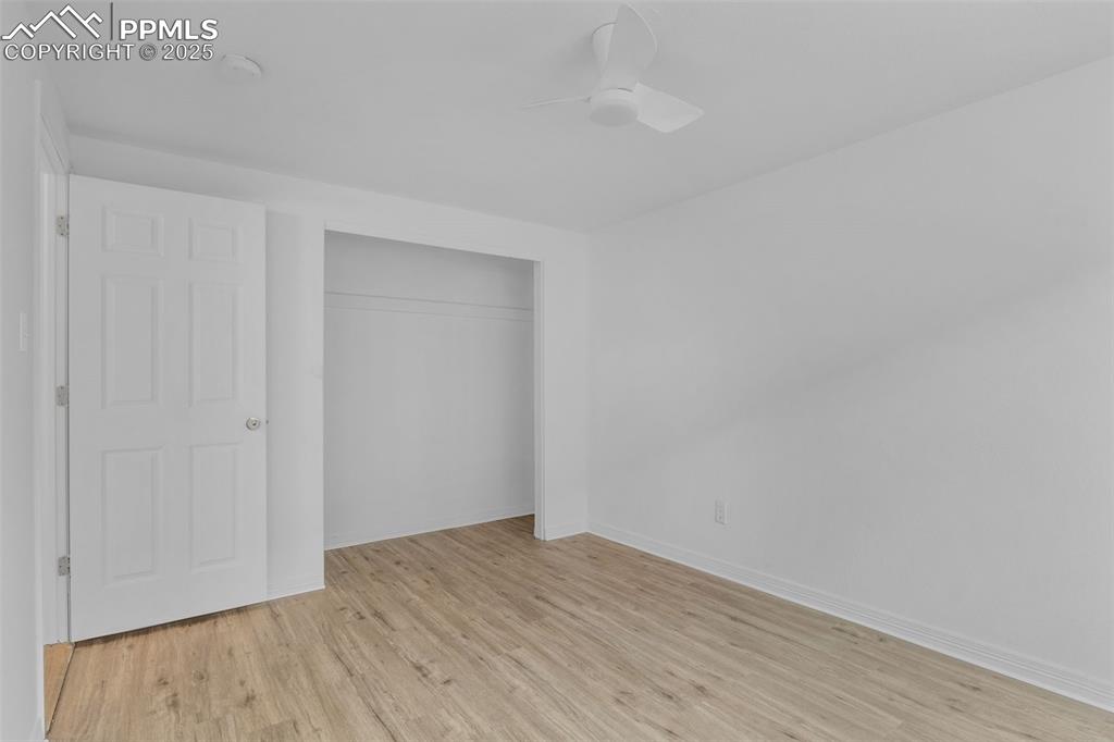 Image 12 of 17: Unfurnished bedroom featuring light wood-style floors, a closet, and ceilin