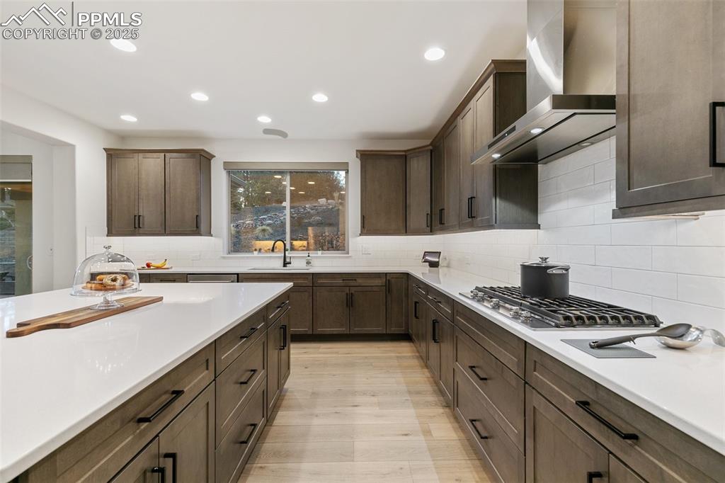 Image 15 of 49: Gourmet kitchen with double ovens and gas cook top
