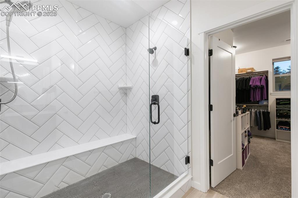 Image 26 of 49: Tiled shower with penny tile accents