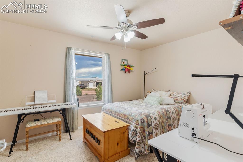 Image 19 of 33: Bedroom featuring light colored carpet and a ceiling fan