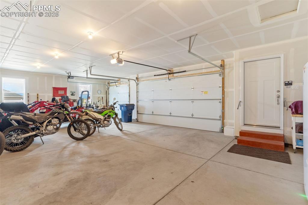 Image 26 of 33: Garage featuring a garage door opener