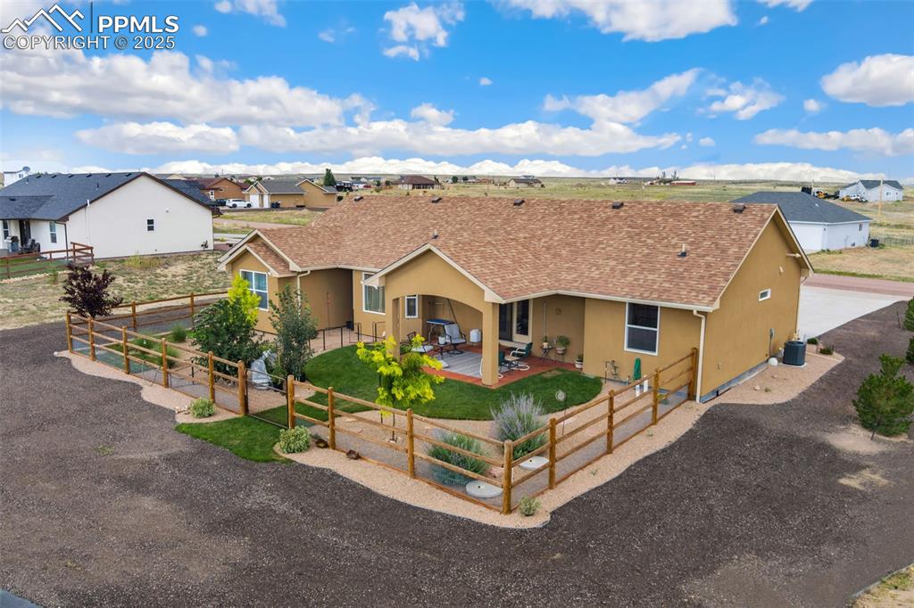 Image 28 of 33: Ranch-style home featuring stucco siding, a patio area, roof with shingles,