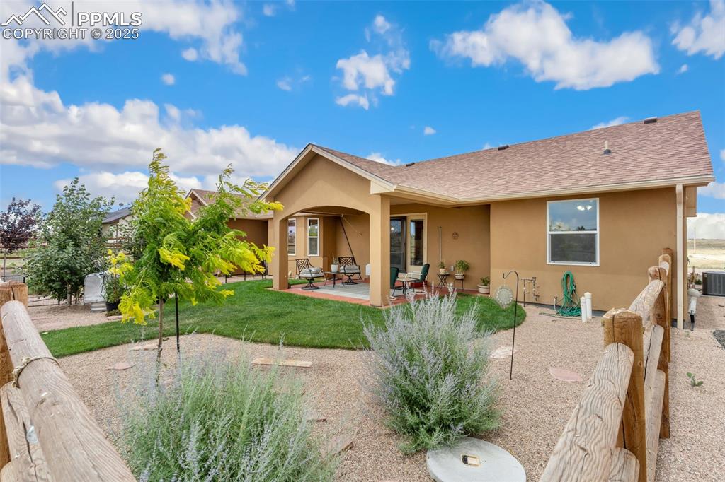 Image 3 of 33: Back of house featuring stucco siding and a patio area