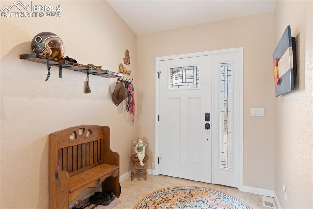 Image 5 of 33: Entrance foyer featuring baseboards and light tile patterned floors