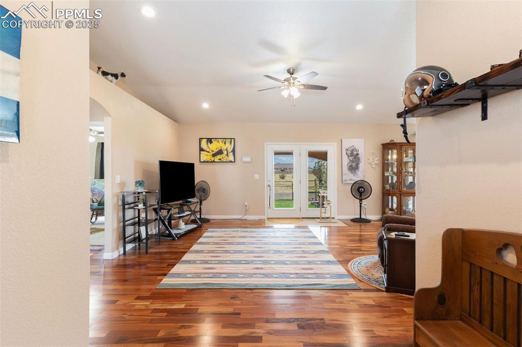 Image 6 of 33: Living room with a ceiling fan, wood finished floors, recessed lighting, an