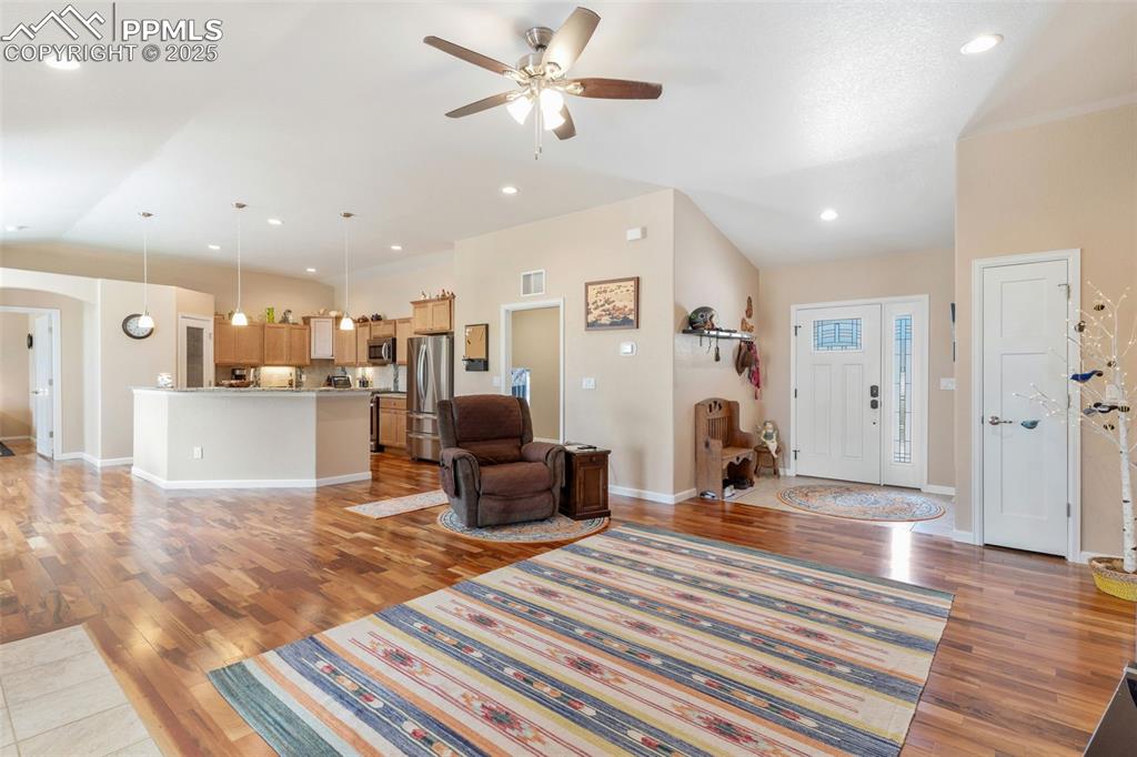 Image 8 of 33: Living room featuring light wood finished floors, arched walkways, a ceilin