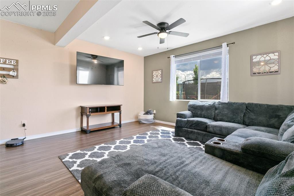 Image 12 of 37: Living room with ceiling fan