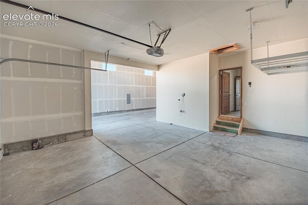 Image 33 of 38: Spacious room with light-toned carpeting and white walls