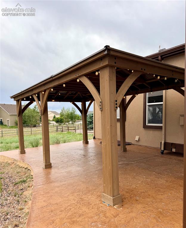 Image 36 of 38: Expansive property featuring a brown ranch-style home with a covered front