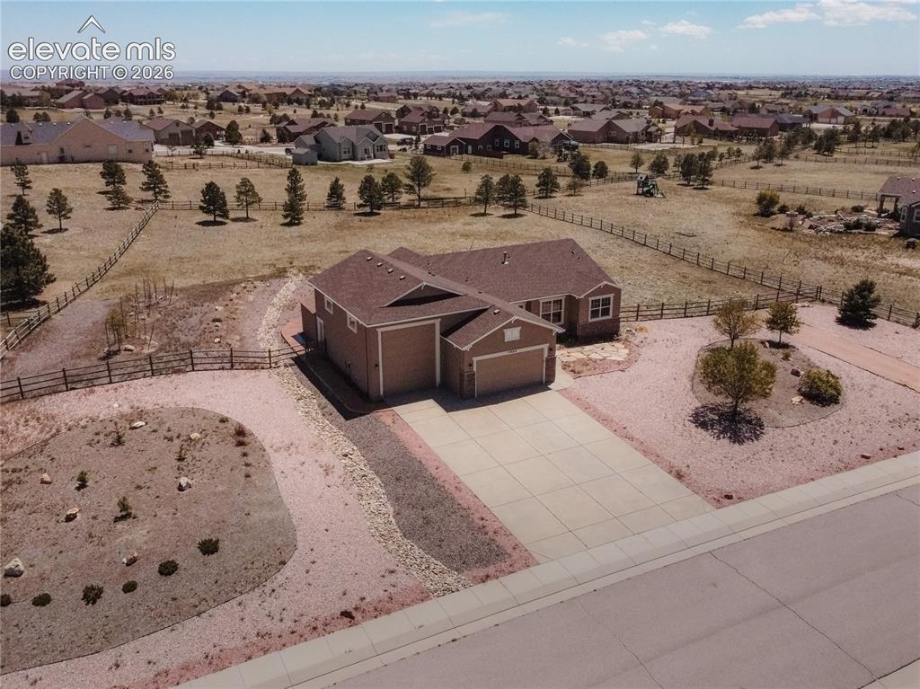 Image 45 of 48: Single-story property featuring a multi-car garage, concrete driveway, and