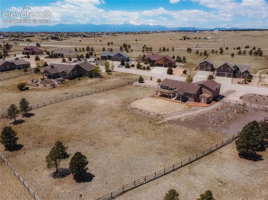 Image 46 of 48: Spacious property featuring a brown ranch-style home with a covered porch a