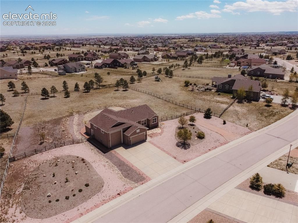 Image 47 of 48: Single-family residence featuring an attached garage, a paved driveway, and