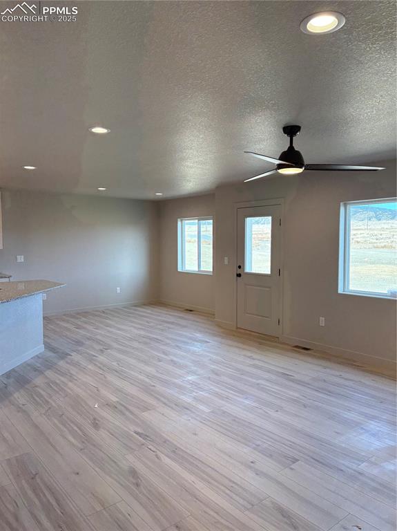 Image 6 of 16: Unfurnished living room featuring recessed lighting, light wood-style floor