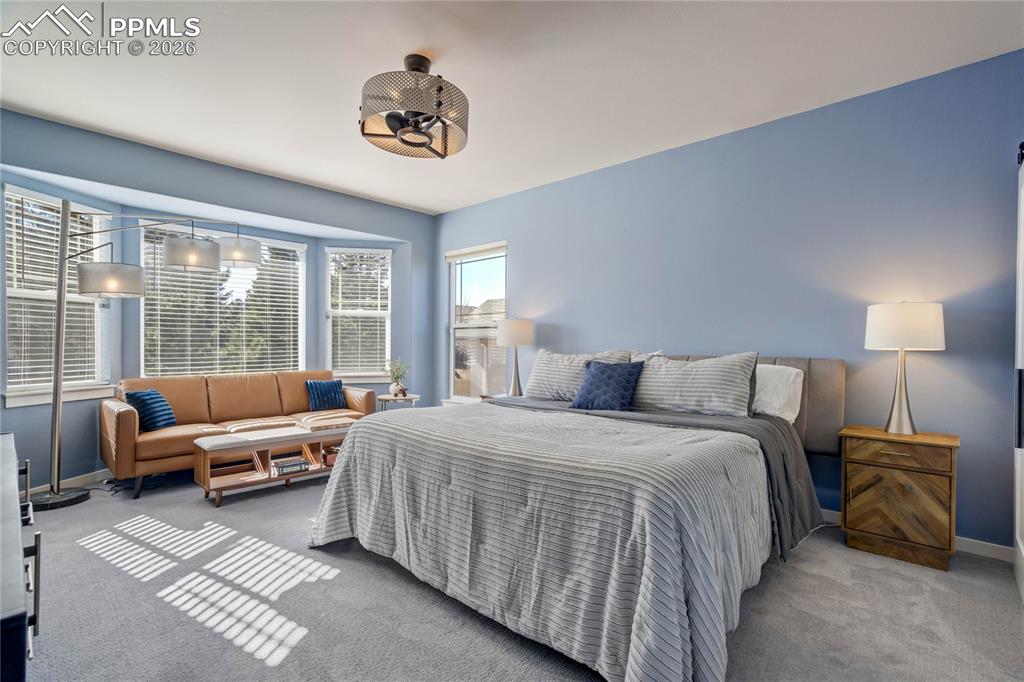 Image 22 of 50: Main level primary suite is the ideal escape!