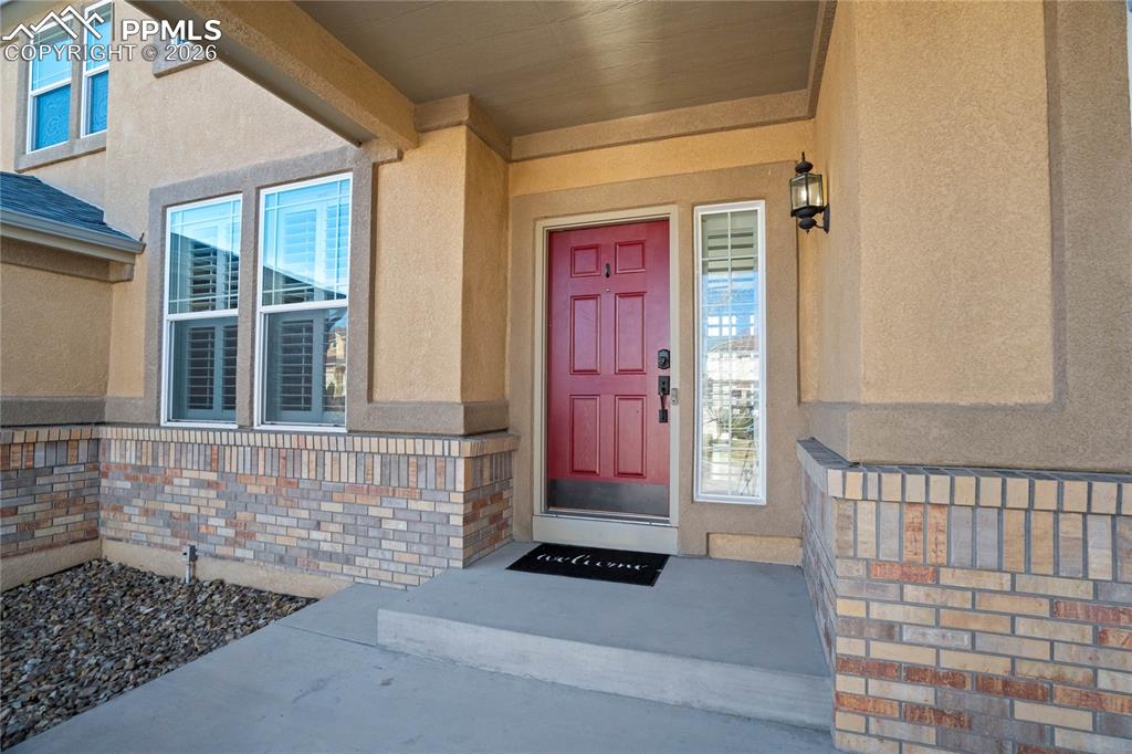 Image 4 of 50: Covered front porch with welcoming red door that welcomes you home!