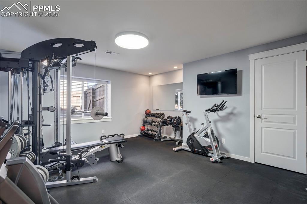 Image 42 of 50: Lower level bedroom could be exercise room. Currently set up that way.