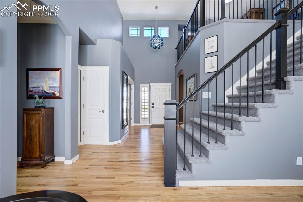 Image 6 of 50: Entry showcasing the staircase to the upper level.