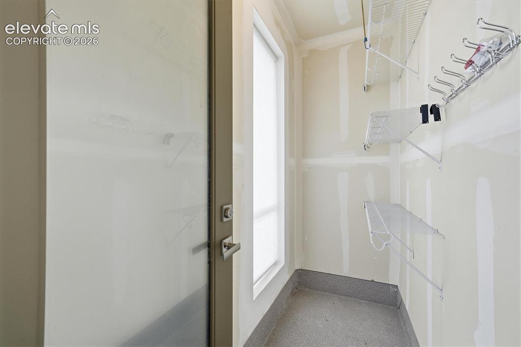 Image 27 of 47: Storage with shelving and hooks