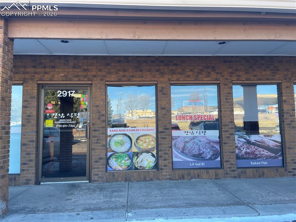 Caption: Entrance to property featuring brick siding