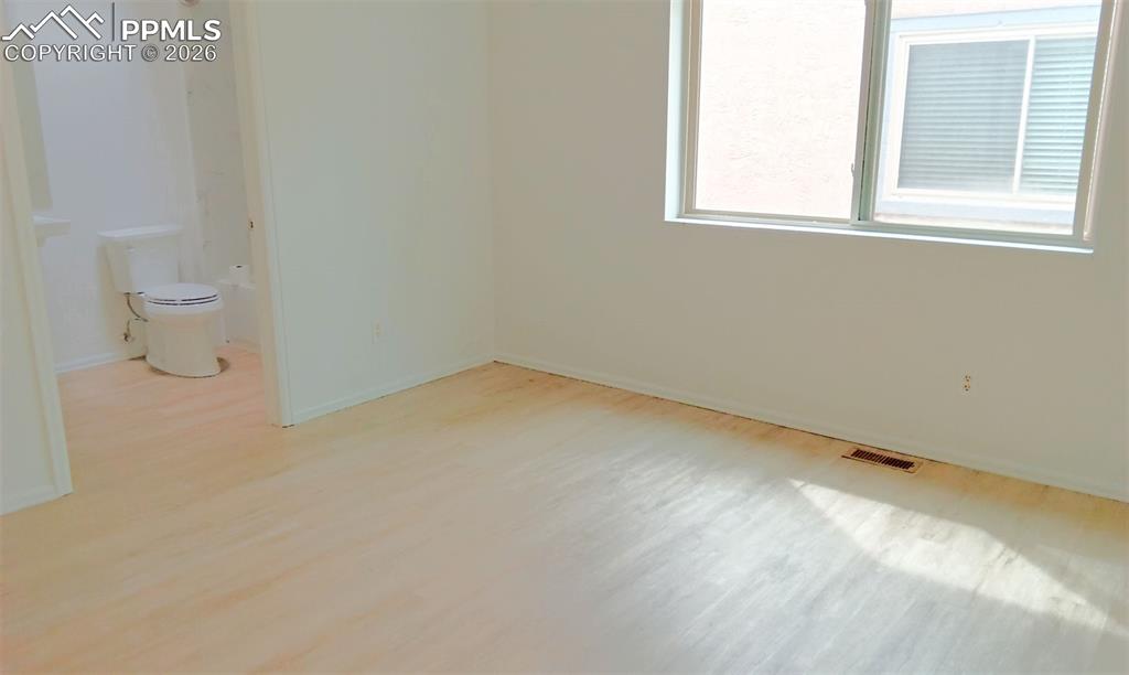 Image 10 of 13: Primary bedroom with double closets and ensuite