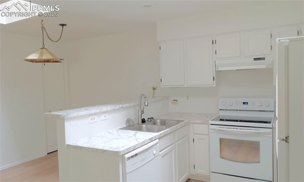 Image 4 of 13: kitchen/dining room with skylights
