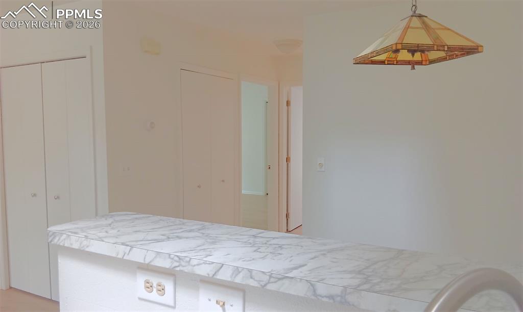 Image 6 of 13: kitchen/laundry closet in hallway/primary bedroom