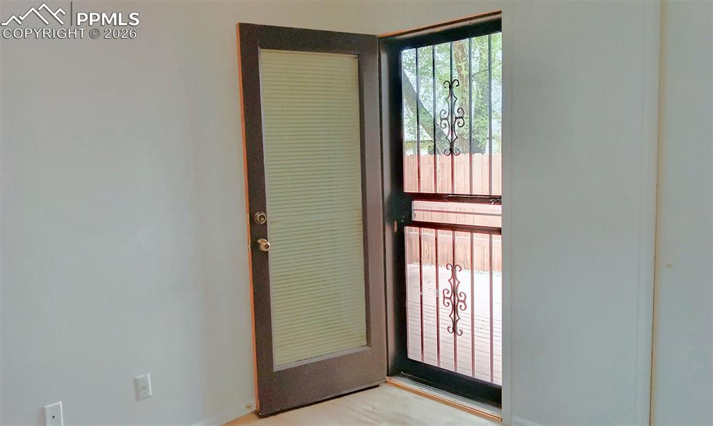 Image 7 of 13: 2nd bedroom entrance to back patio