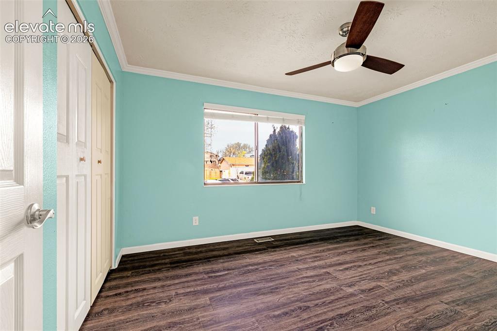 Image 13 of 20: Primary bedroom with ceiling fan