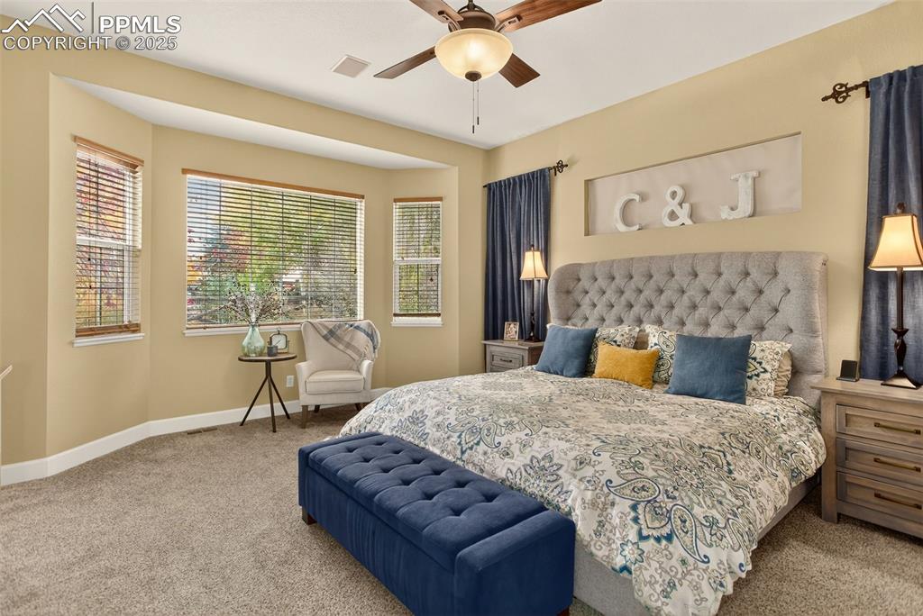 Image 17 of 40: Bedroom with carpet floors and a ceiling fan