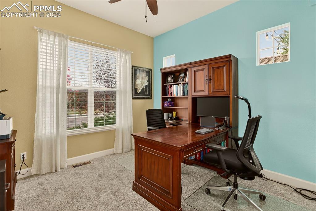 Image 21 of 40: Office area featuring healthy amount of natural light, light carpet, and a