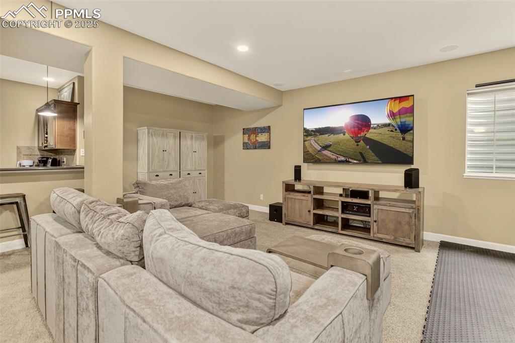Image 24 of 40: Home theater with light carpet and baseboards