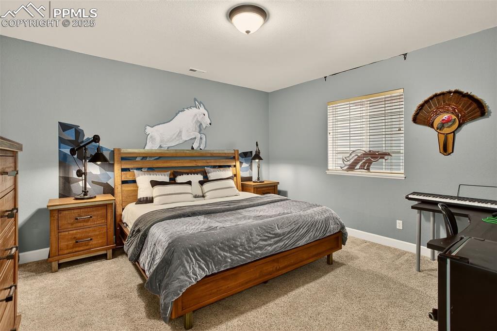 Image 30 of 40: Bedroom featuring light carpet and baseboards
