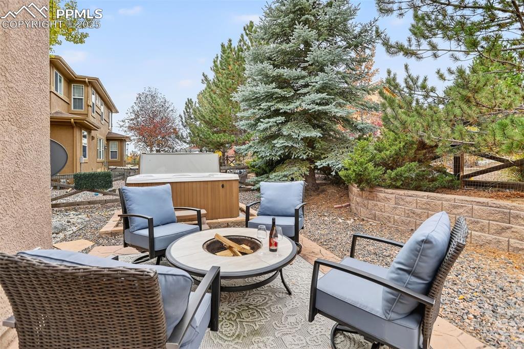 Image 36 of 40: View of patio / terrace featuring a hot tub and a fire pit