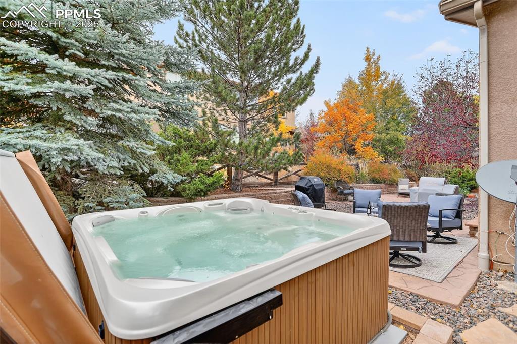 Image 37 of 40: View of patio featuring a hot tub and a grill