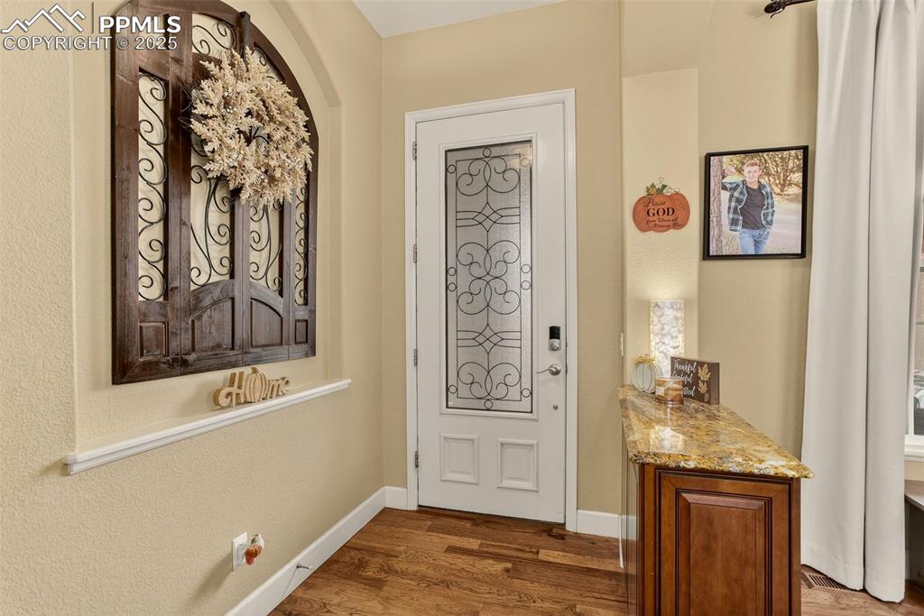 Image 4 of 40: Foyer entrance featuring dark wood-type flooring and baseboards